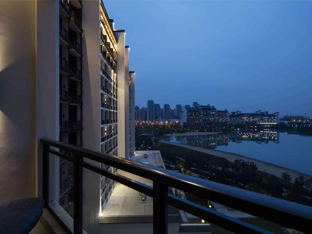 a balcony of a building with a view of the water at Novotel Hefei Sunac in Hefei
