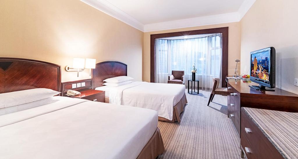 Postel nebo postele na pokoji v ubytování Millennium Harbourview Hotel Xiamen-Near Metro Station & Zhongshan Road