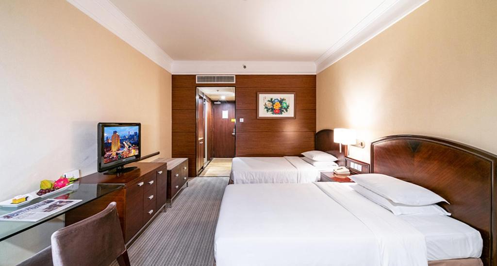 Postel nebo postele na pokoji v ubytování Millennium Harbourview Hotel Xiamen-Near Metro Station & Zhongshan Road