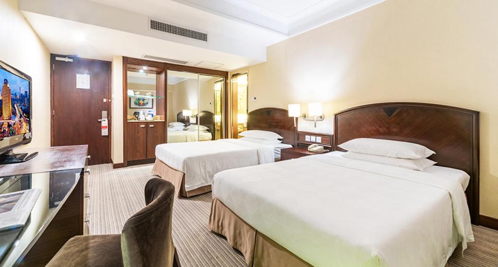 Postel nebo postele na pokoji v ubytování Millennium Harbourview Hotel Xiamen-Near Metro Station & Zhongshan Road