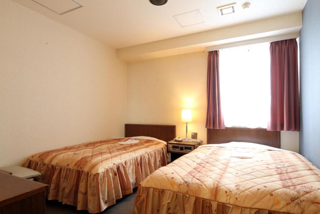 Postel nebo postele na pokoji v ubytování Hotel Pao