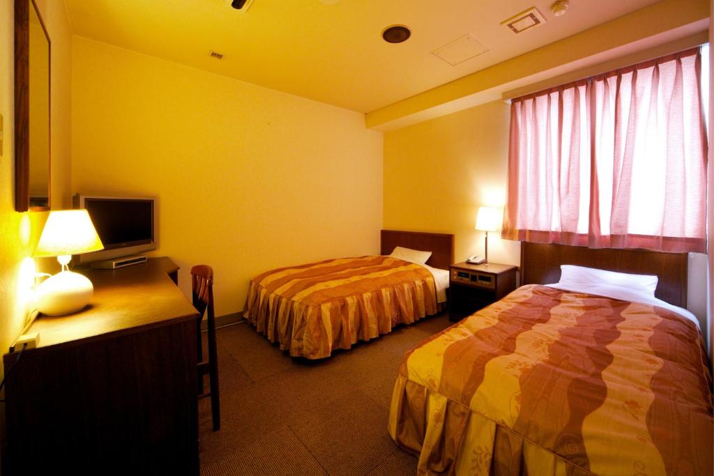 Postel nebo postele na pokoji v ubytování Hotel Pao