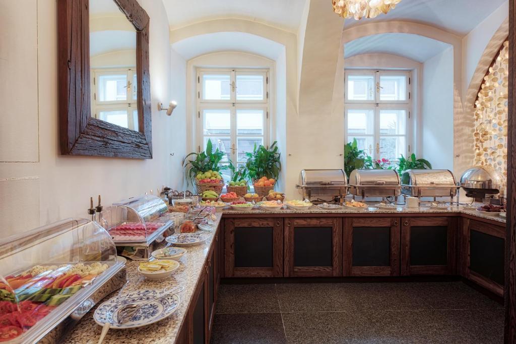 a buffet line with food in a room with windows at Hotel Residence Agnes in Prague