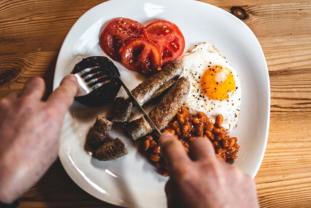 a plate of breakfast food with eggs and beans at Bluewater Beachfront Guest House in Port Elizabeth