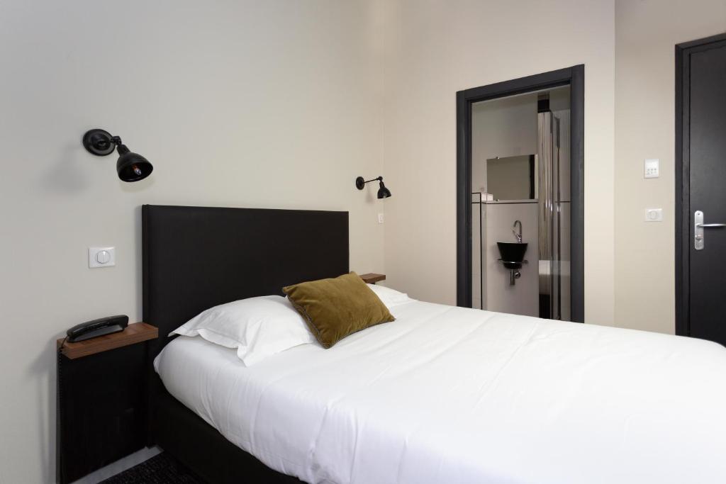 Postel nebo postele na pokoji v ubytování Babbu Hotel