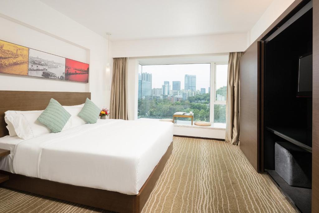 Postel nebo postele na pokoji v ubytování 广州友和酒店Yuwa Hotel-Free Shuttle Bus to Canton Fair Complex DuringCanton Fair Period
