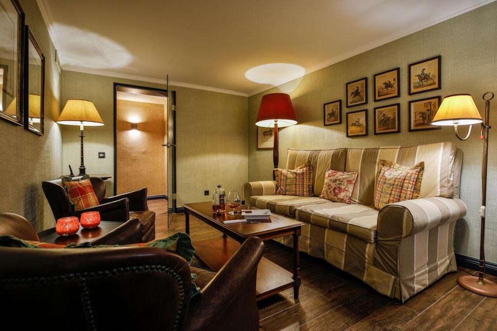 a living room with a couch and a table at Hotel Stadt Hamburg in Westerland