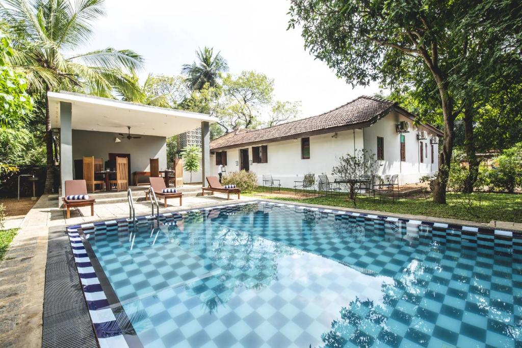 a swimming pool in front of a house at Thambu Illam in Jaffna