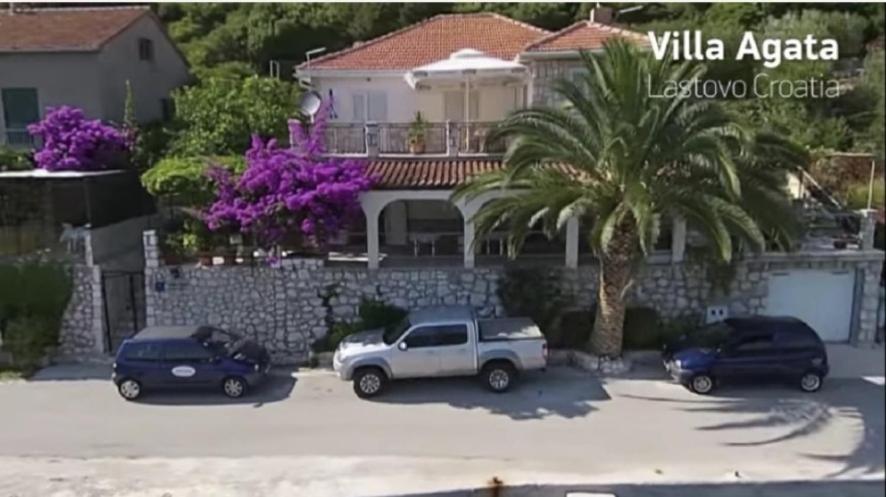 three cars parked in a parking lot in front of a house at Villa Agata in Lastovo