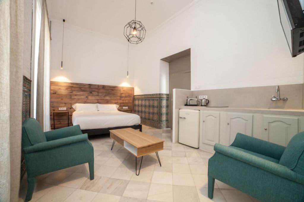 Postel nebo postele na pokoji v ubytování Apartahotel Siglo XIX