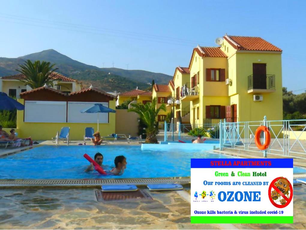 a child swimming in a swimming pool at a hotel at Stella Apartments in Marathokampos