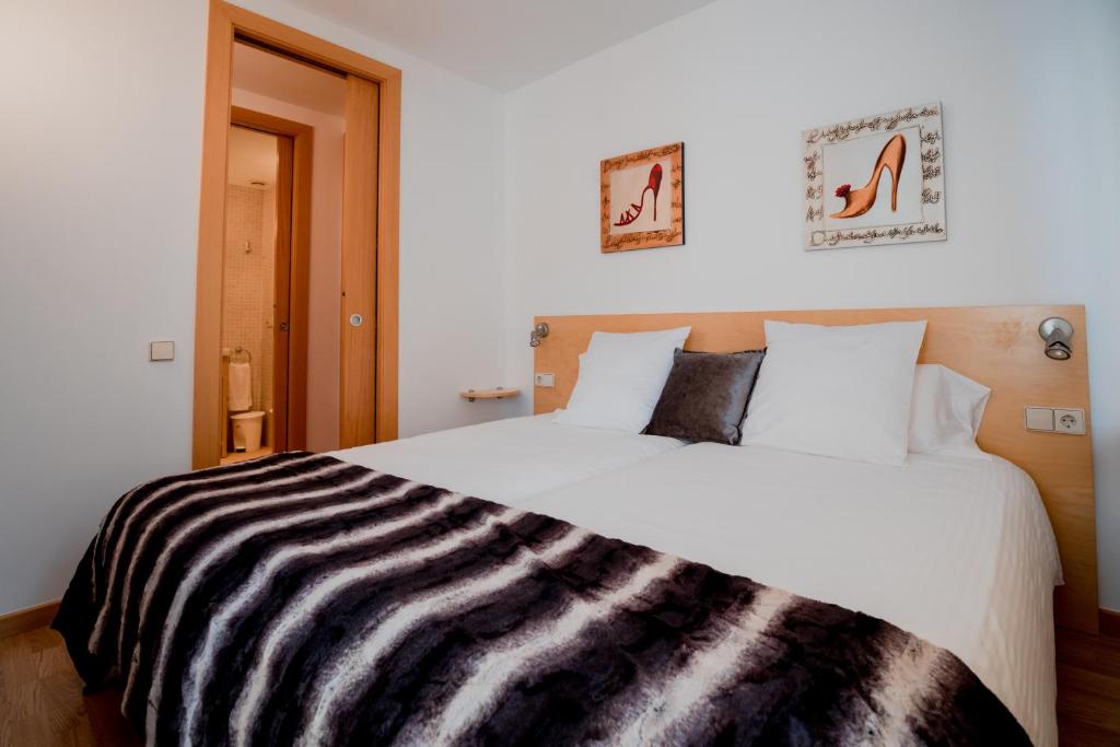 Postel nebo postele na pokoji v ubytování Apartaments Ashome