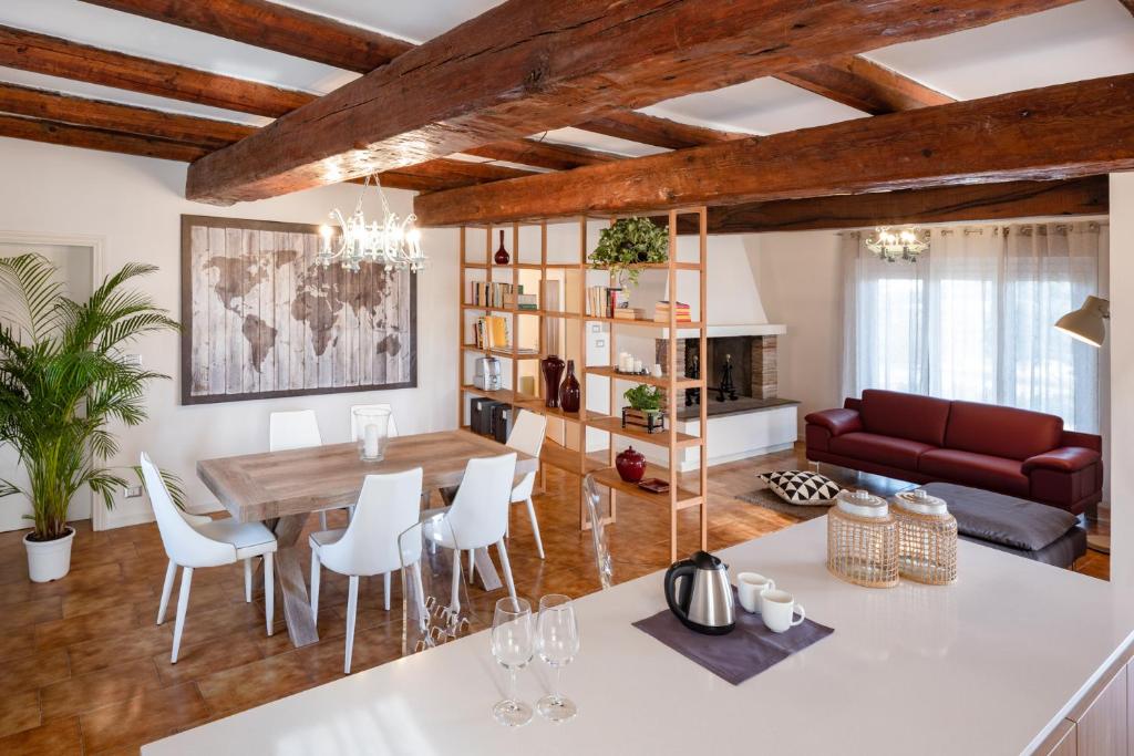 a dining room and living room with a table and chairs at Le Radici in Isola del Piano