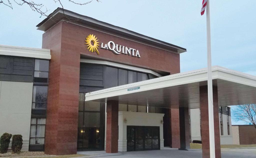 a large building with a sign on the front of it at La Quinta by Wyndham Boston-Andover in Andover