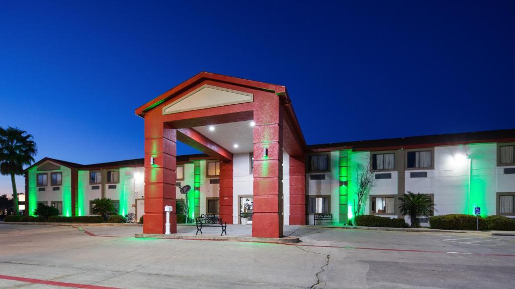 a building with green lights on the front of it at SureStay Hotel by Best Western Orange in Orange