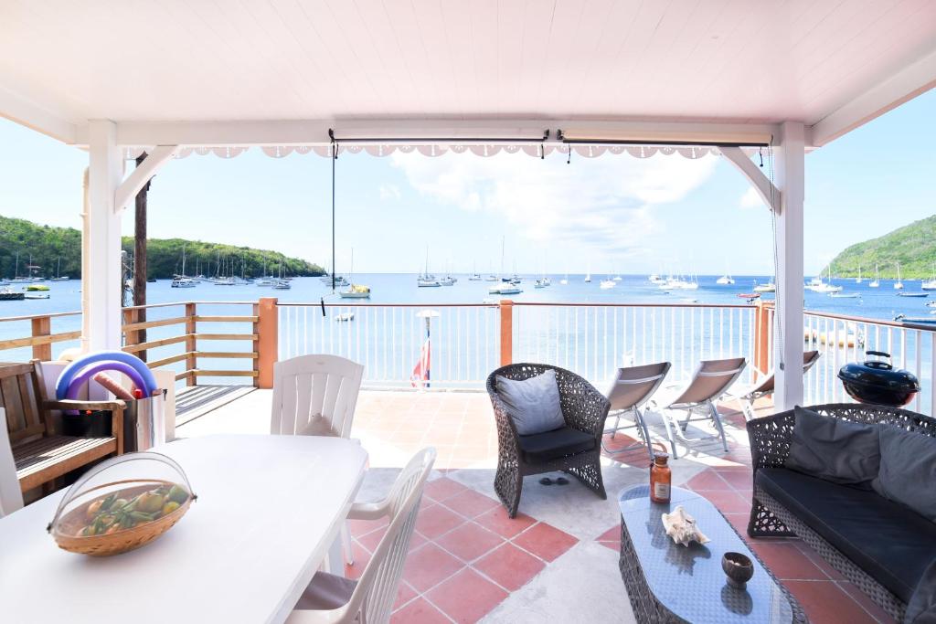 a living room with a view of the water at Lez'arlet Plage in Les Anses-dʼArlets