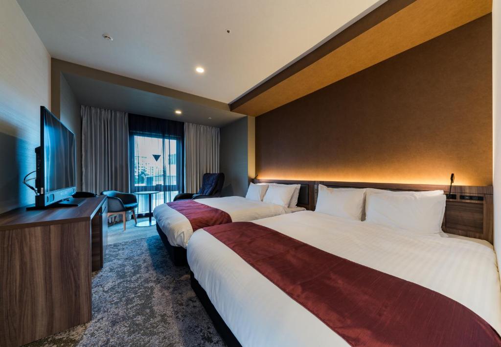 Daiwa Roynet Hotel Hakata Reisen PREMIER - former Daiwa Roynet Hotel Hakata Reisen客房内的一张或多张床位