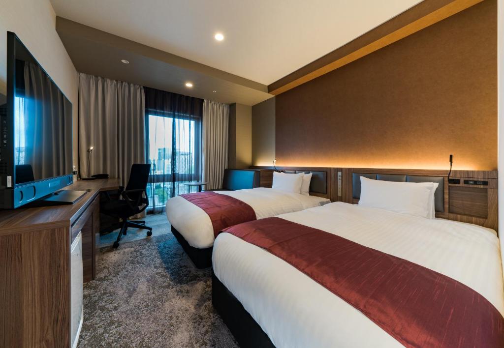 Daiwa Roynet Hotel Hakata Reisen PREMIER - former Daiwa Roynet Hotel Hakata Reisen客房内的一张或多张床位