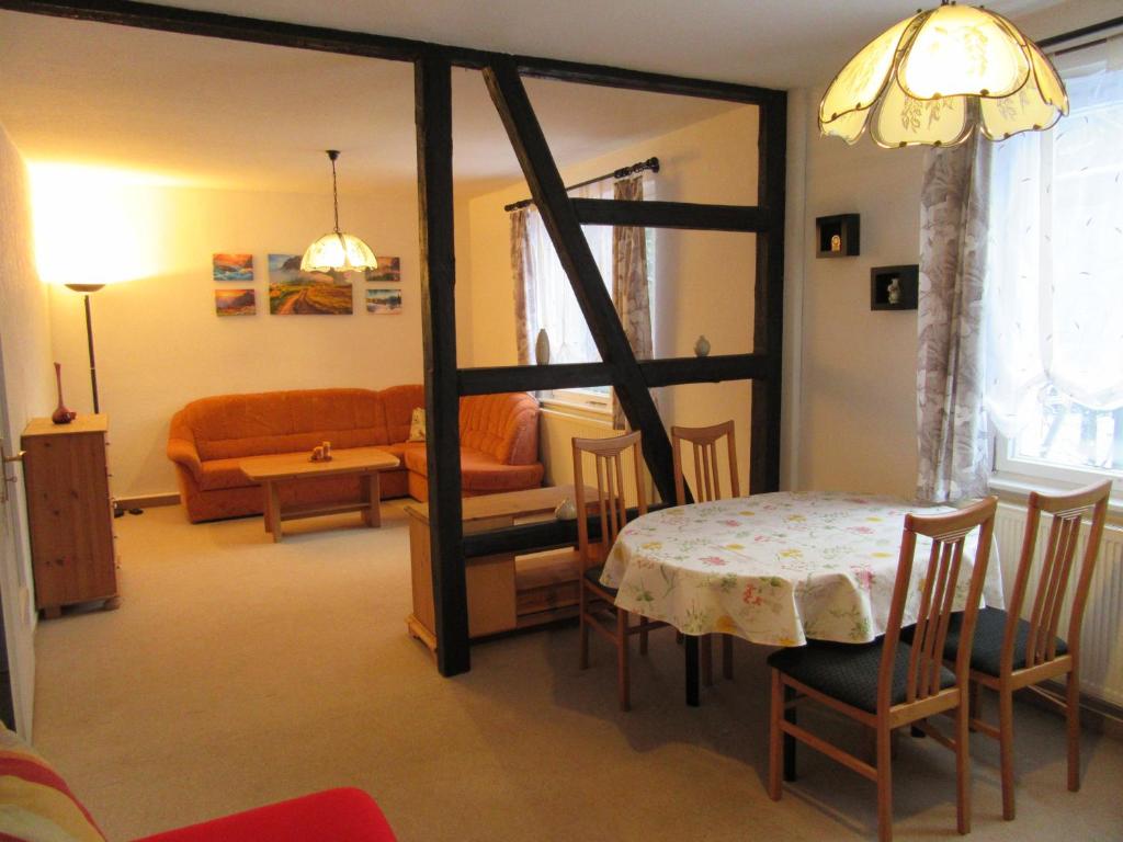a living room with a table and a couch at Haus Hasenmüller in Schmiedefeld am Rennsteig