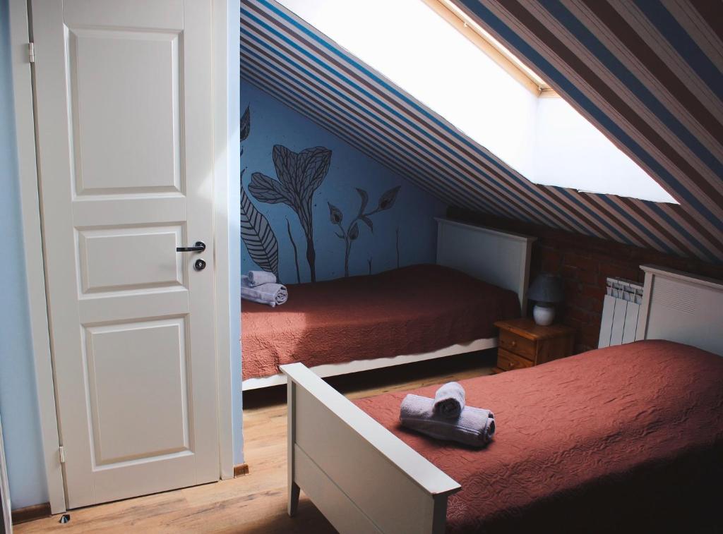 a bedroom with two beds in a attic at Guesthouse Mõisa Ait in Võru