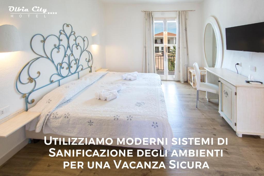 Postel nebo postele na pokoji v ubytování Olbia City Hotel