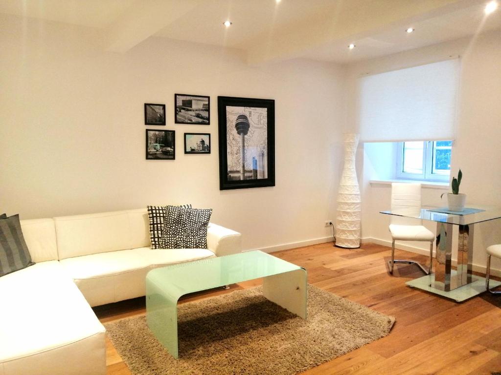 a living room with a white couch and a table at Apartments Spittelberg Gardegasse in Vienna