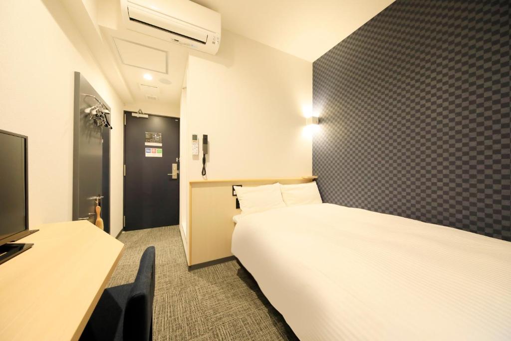 Postel nebo postele na pokoji v ubytování Hotel NewNagano NeXT