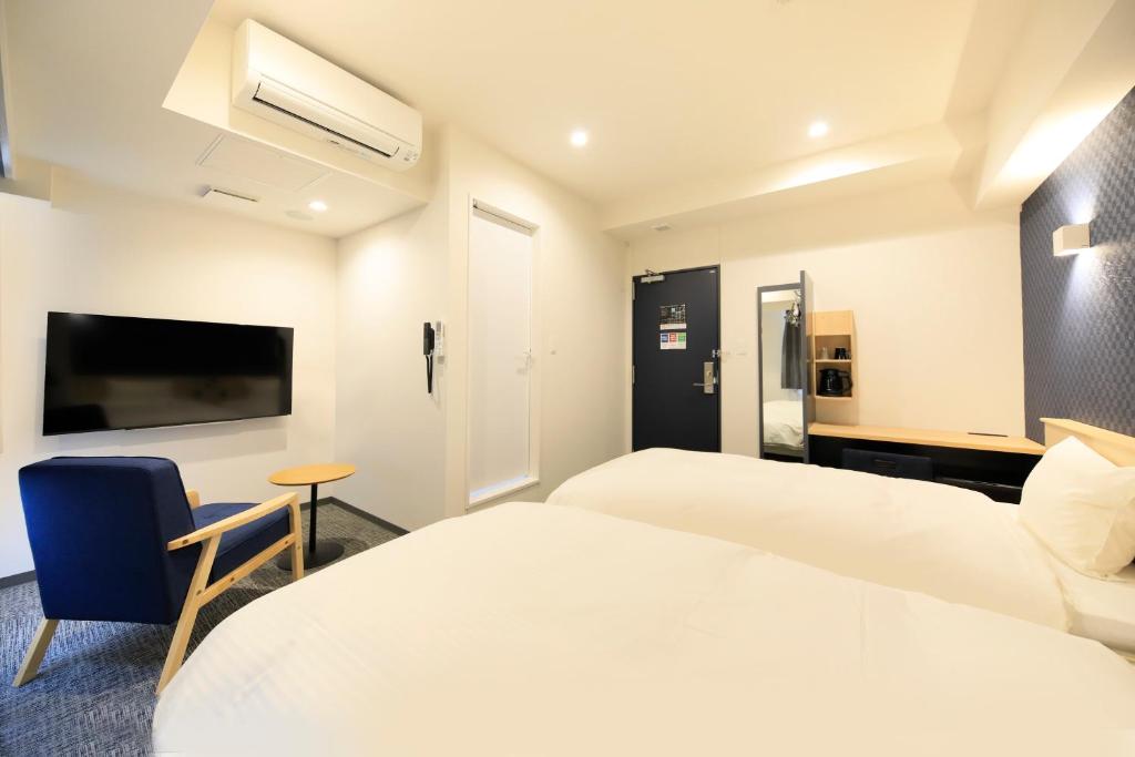 Postel nebo postele na pokoji v ubytování Hotel NewNagano NeXT