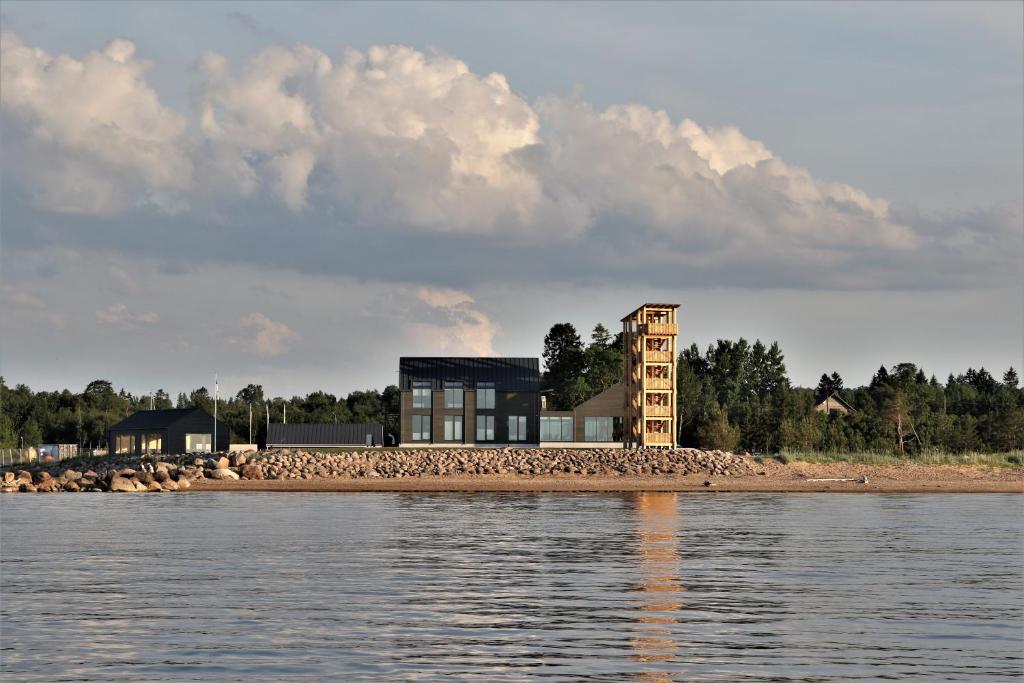 a house on the shore of a body of water at Tulivee Villa in Liimala