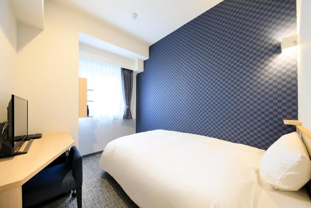 Postel nebo postele na pokoji v ubytování Hotel NewNagano NeXT