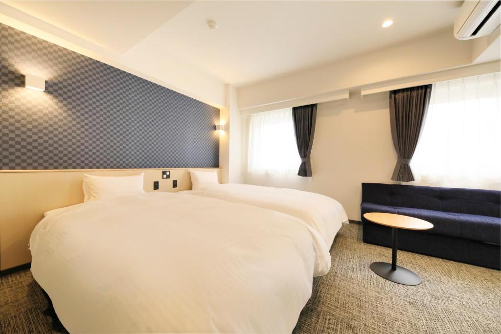Postel nebo postele na pokoji v ubytování Hotel NewNagano NeXT
