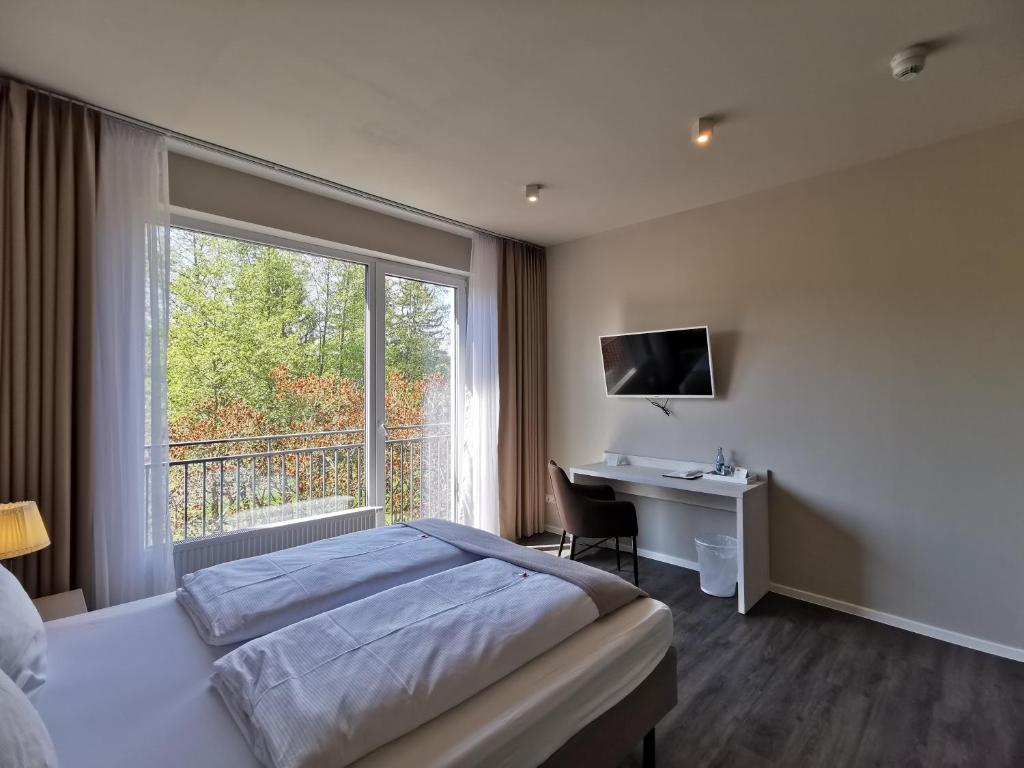 Postel nebo postele na pokoji v ubytování Hotel Gutsmühle