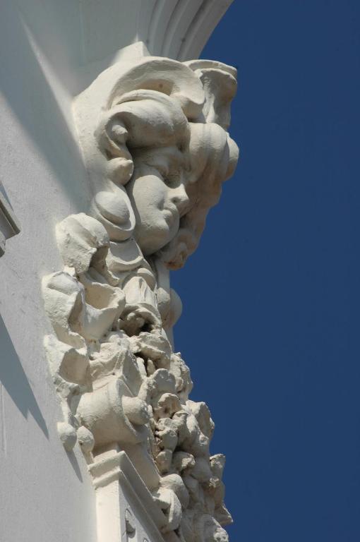 a stone statue on the side of a building at Hotel Splendid in Cannes