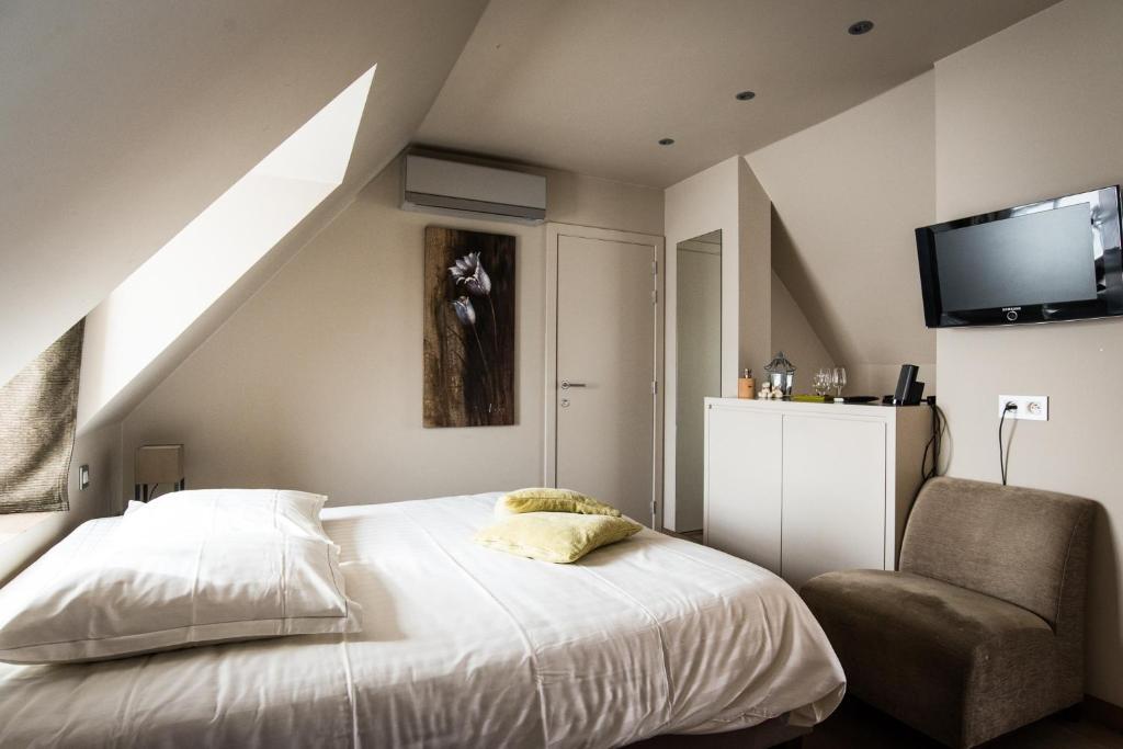 Postel nebo postele na pokoji v ubytování Hotel de la Paix