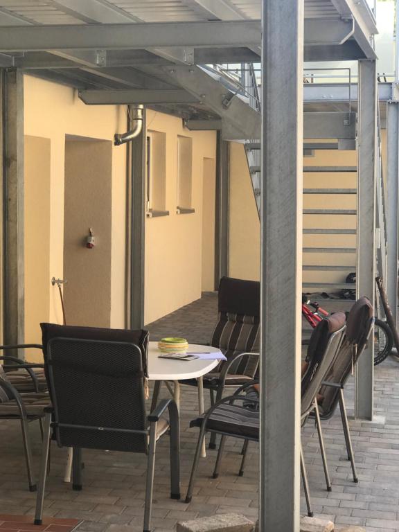 a patio with chairs and a table and a table and chairs at Haus Rheinsheimer Scheuer in Philippsburg