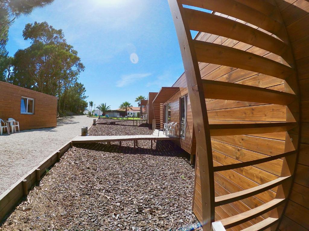 a building with a wooden staircase on the side of it at Golden Halcyon - Ericeira Villas in Ericeira