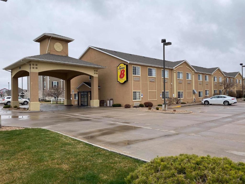 a hotel with a parking lot in front of it at Super 8 by Wyndham Great Bend in Great Bend