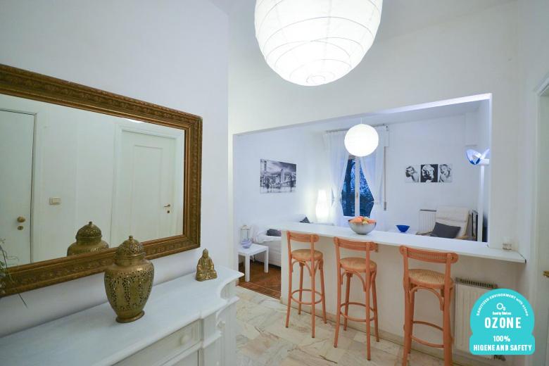 Sala de estar con espejo y barra con taburetes en Holiday Home Santa Margherita Ligure, en Santa Margherita Ligure