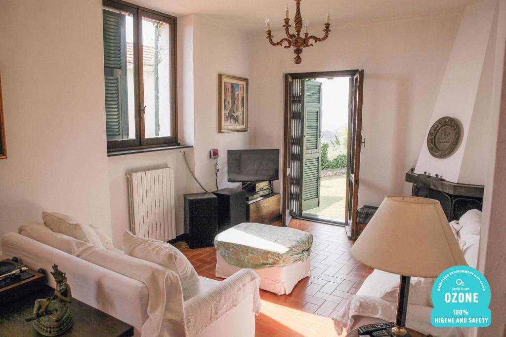 a living room with a couch and a mirror at Holiday Home Chiavari in Chiavari