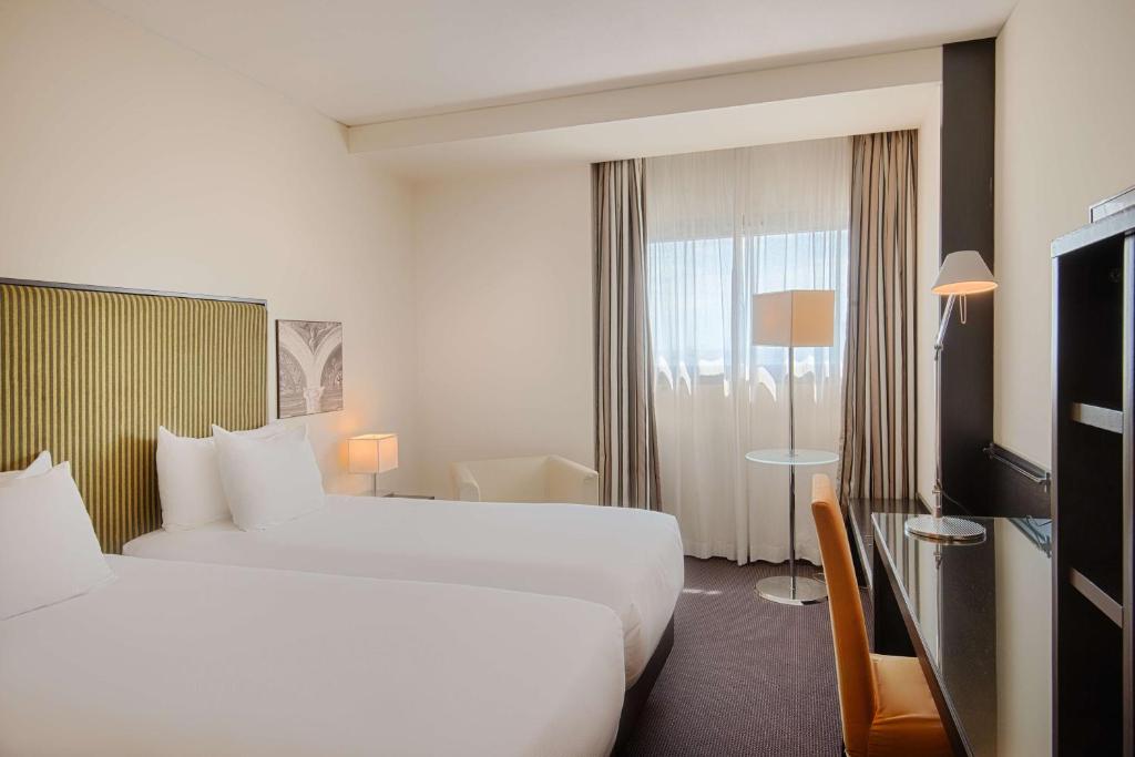 Postel nebo postele na pokoji v ubytování Savhotel Mantegna Padova