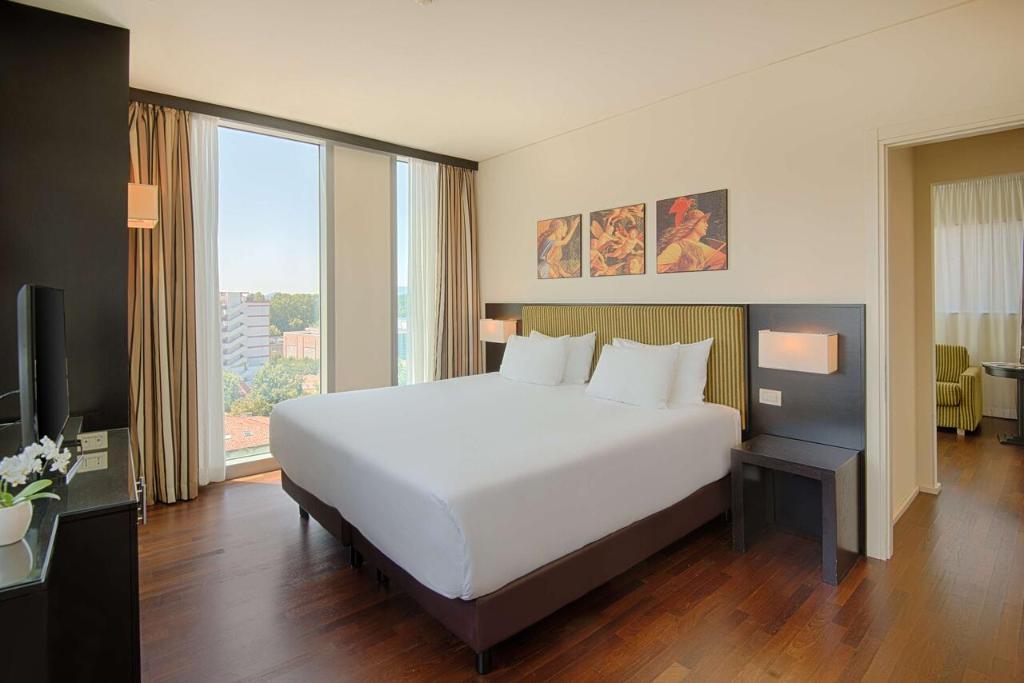 Postel nebo postele na pokoji v ubytování Savhotel Mantegna Padova