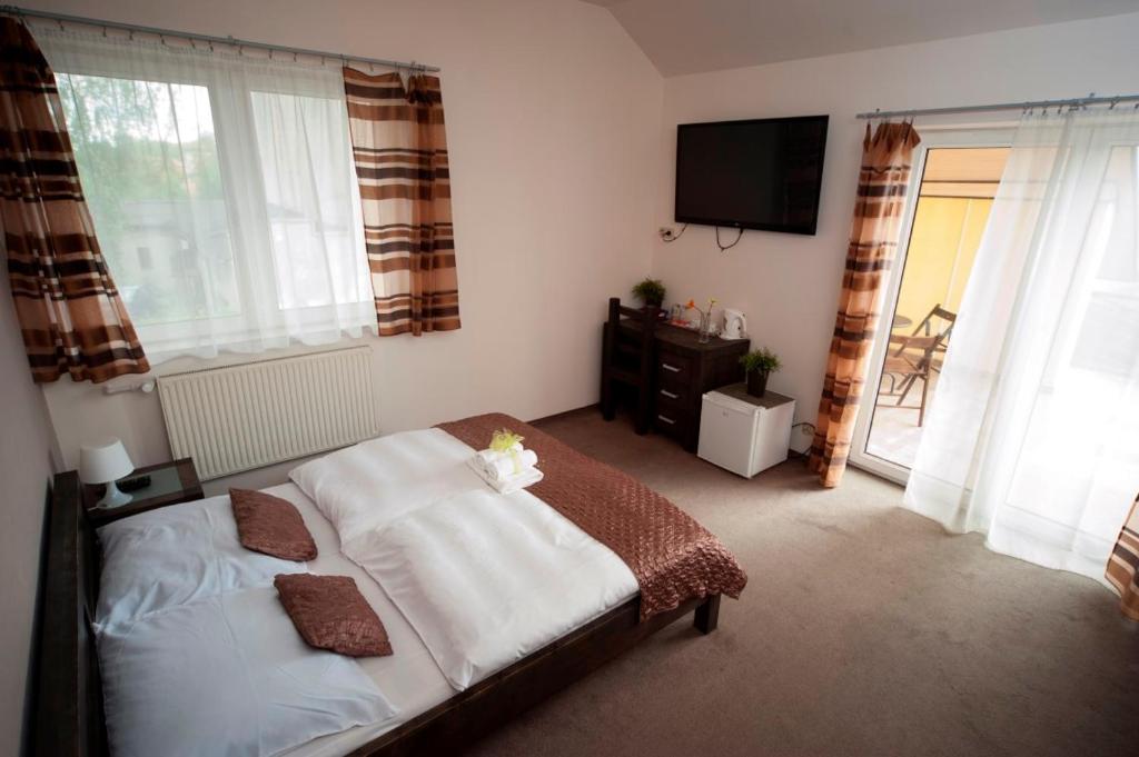 a bedroom with a bed and a flat screen tv at BedRooms 3 Maja 15A in Łódź