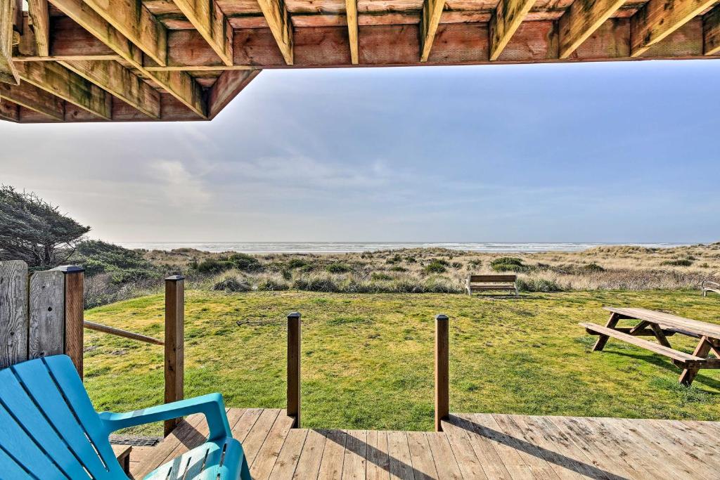 a deck with a bench and a picnic table at Sanderling Sea Cottages, Unit 13 in Waldport