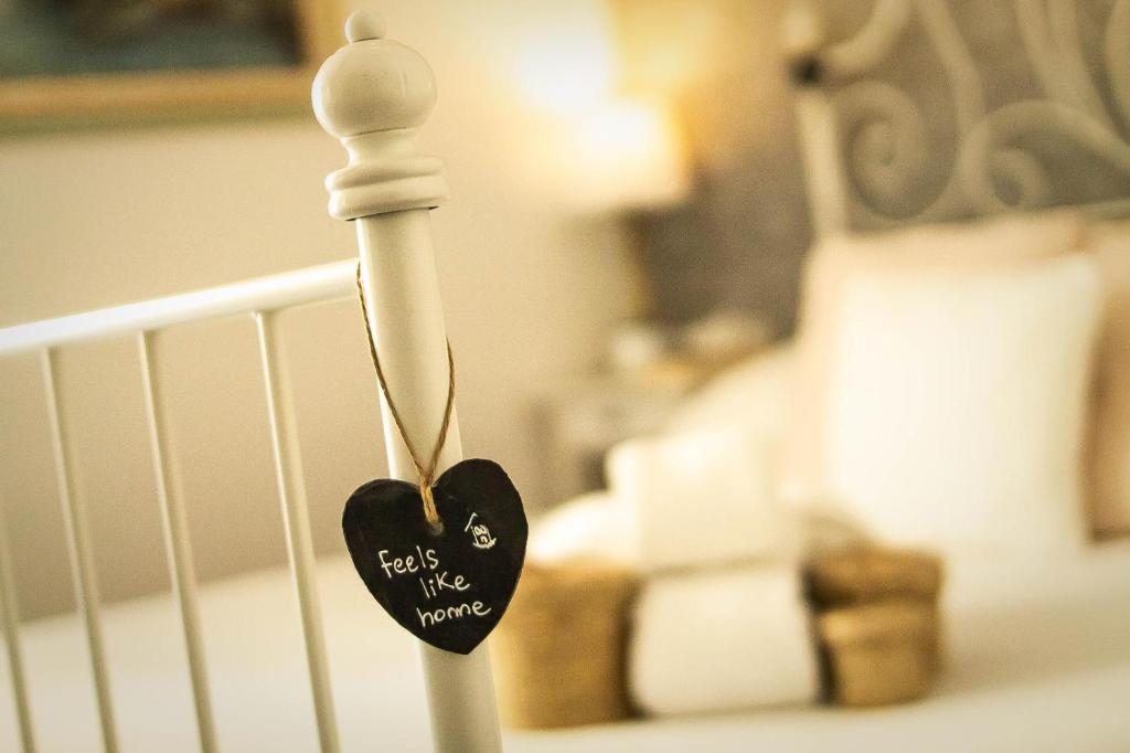 a crib with a black heart hanging on it at Guest House Camilla in Alghero
