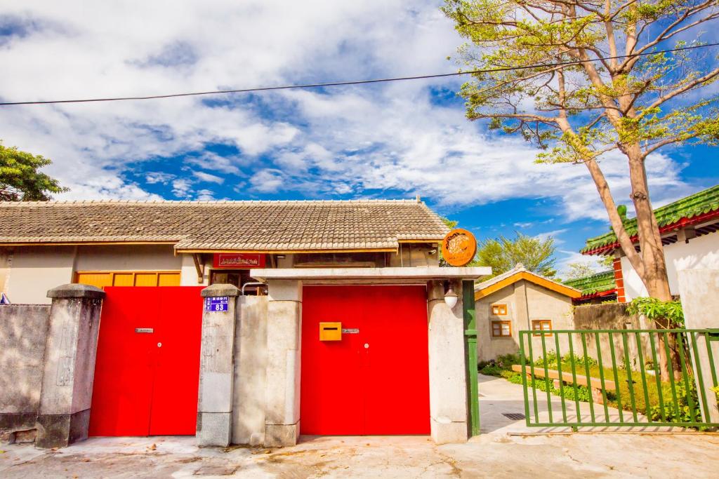 una casa roja con dos puertas de garaje rojas en CandyFloss 棉花糖民宿 遊高雄 en Kaohsiung