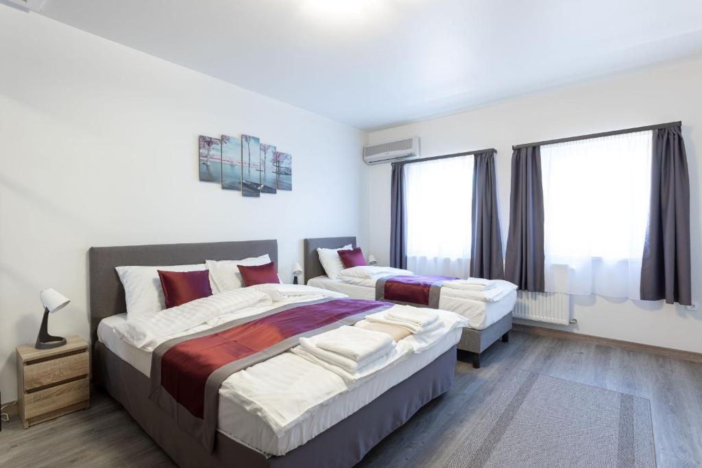 A bed or beds in a room at Hooper's Vendégház