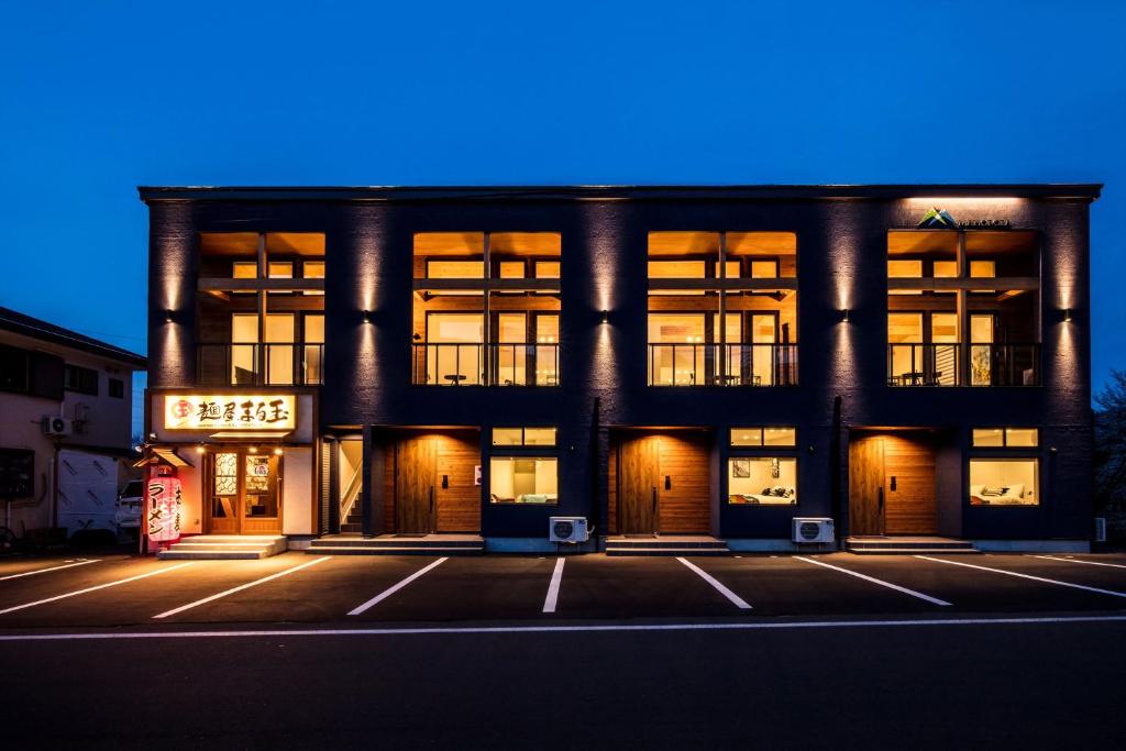 a large building with windows in a city at night at Hakuba MAHOROBA in Hakuba