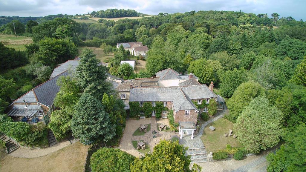 an aerial view of a large house with trees at Boscundle Manor in St Austell