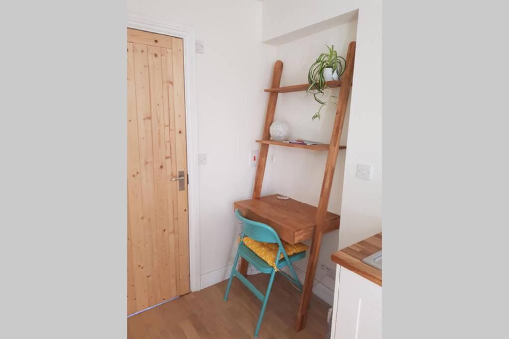 a room with a shelf and a ladder and a stool at Cosy, self contained annex in Cambridge