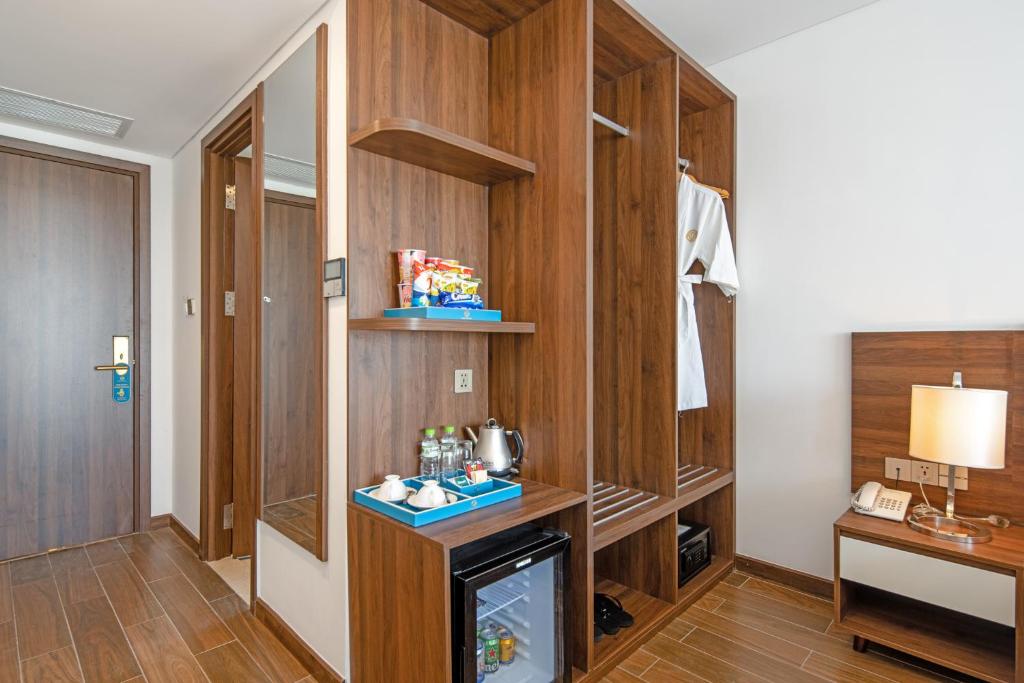 A built-in storage wall with wardrobe, minibar and beverage station.